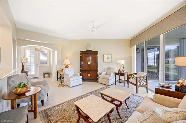 a living room with furniture wooden floor and a large window