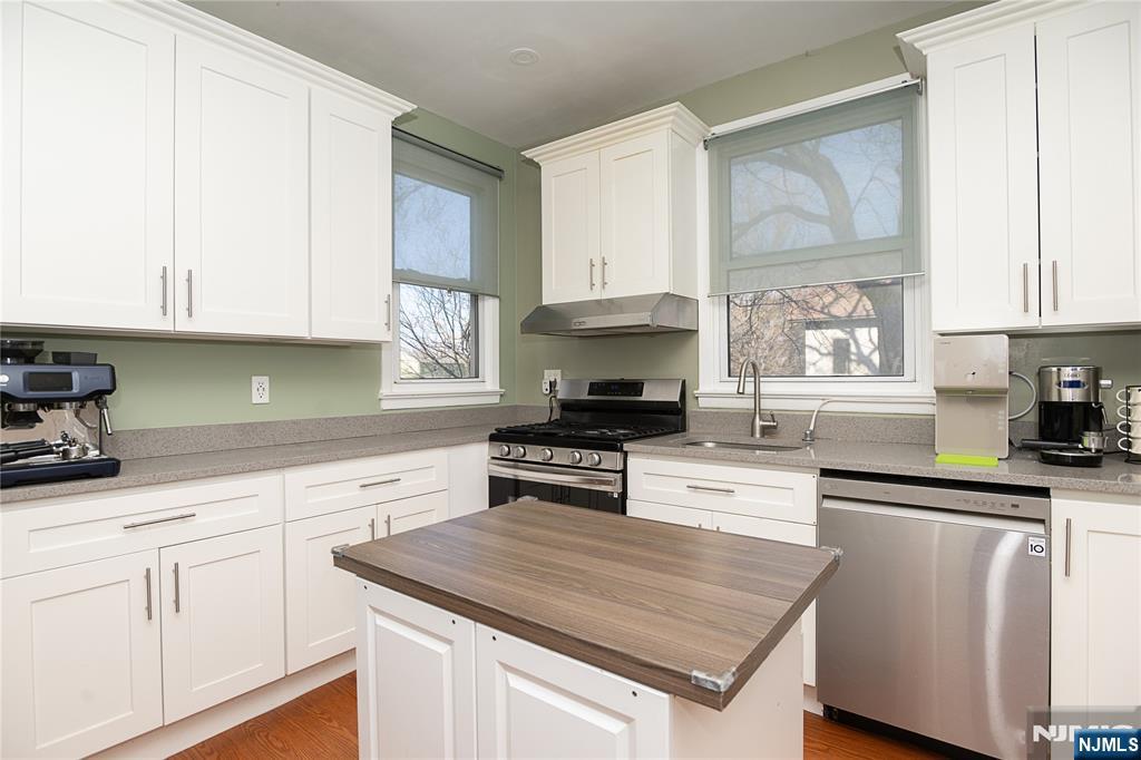 37 Riverside Avenue Little Ferry, NJ 07643 - Photo 16 of 34 a kitchen with granite countertop a sink stainless steel appliances and cabinets