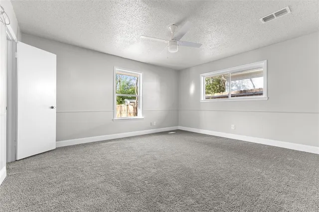 an empty room with windows and closet