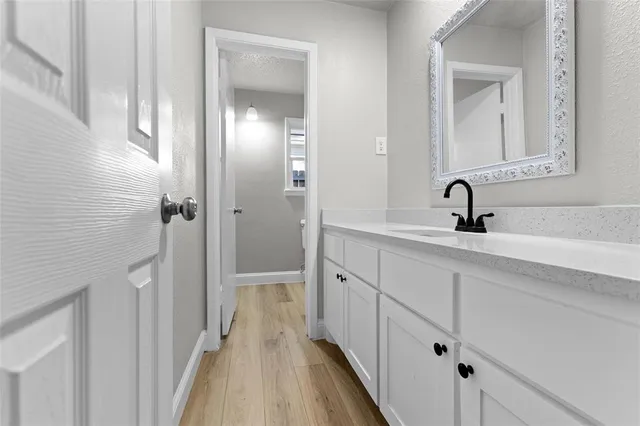a bathroom with a double vanity sink and mirror