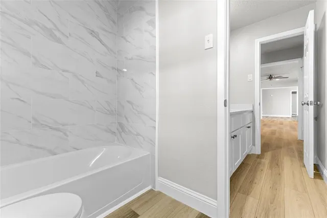 a bathroom with a tub and shower