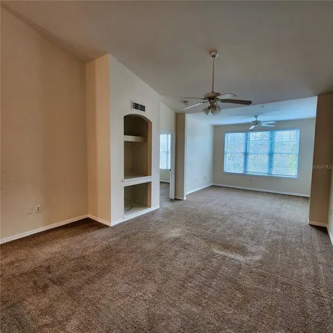 a room with stainless steel appliances granite countertop a sink a stove and a refrigerator