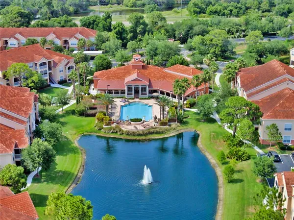 an aerial view of residential houses with outdoor space and trees