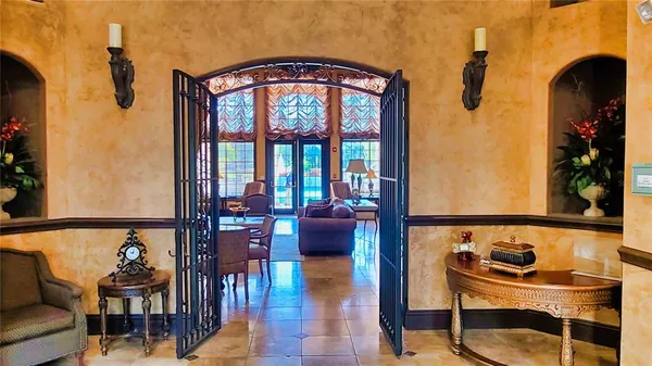 a living room with fireplace furniture and a large window