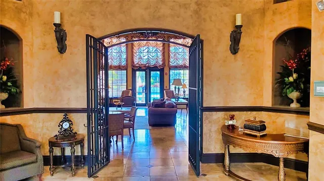 a living room with fireplace furniture and a large window