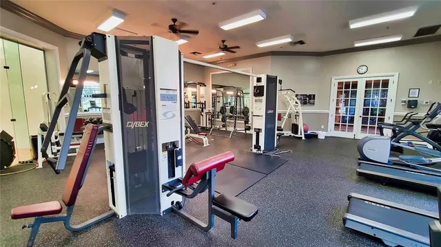 a view of a room with a chandelier fan and kitchen floor