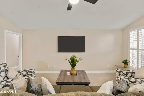 a living room with furniture and a potted plant