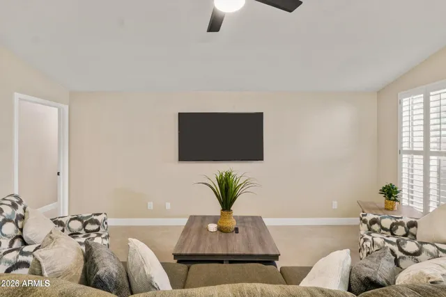 a living room with furniture and a potted plant