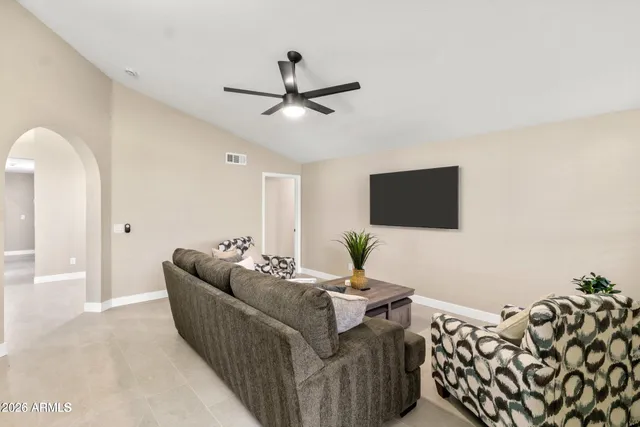a living room with furniture and a flat screen tv