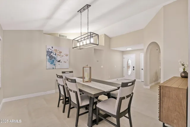 a view of a dining room with furniture a chandelier and wooden floor
