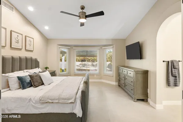 a bedroom with furniture and a flat screen tv