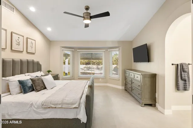 a bedroom with furniture and a flat screen tv