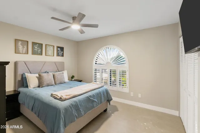 a bedroom with a large bed and a window