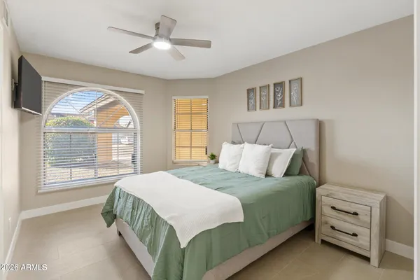 a bedroom with a bed and a chandelier