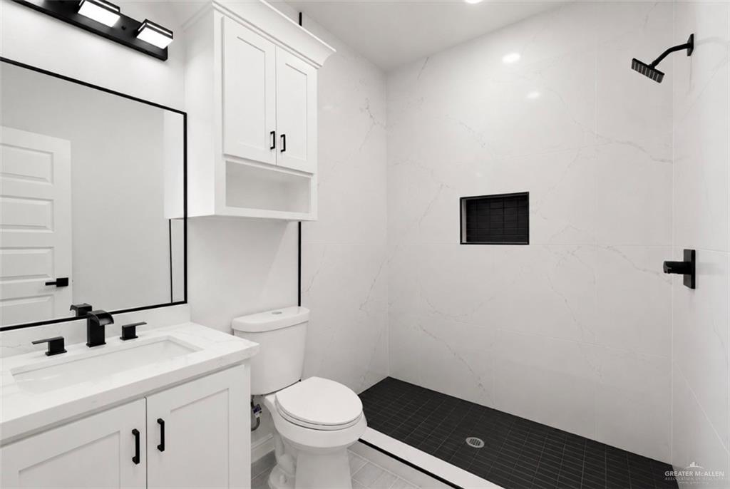 352 Elias Lopez Street Rio Grande City, TX 78582 - Photo 11 of 15 a bathroom with a toilet sink and mirror