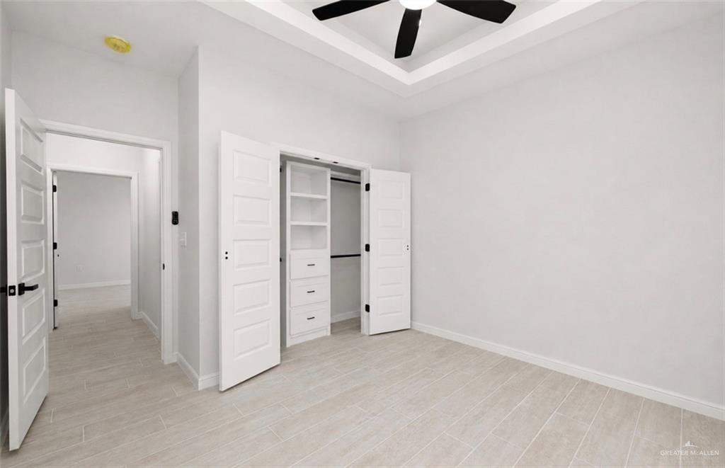 352 Elias Lopez Street Rio Grande City, TX 78582 - Photo 13 of 15 an empty room with closet and a ceiling fan