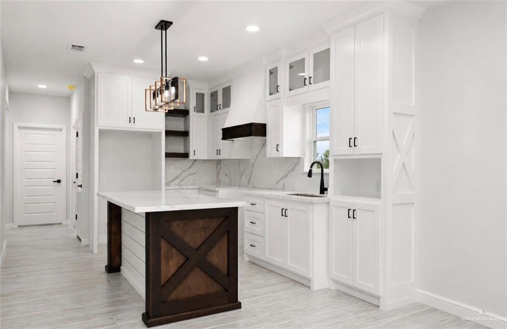 352 Elias Lopez Street Rio Grande City, TX 78582 - Photo 4 of 15 a kitchen with stainless steel appliances a sink a stove a refrigerator and cabinets