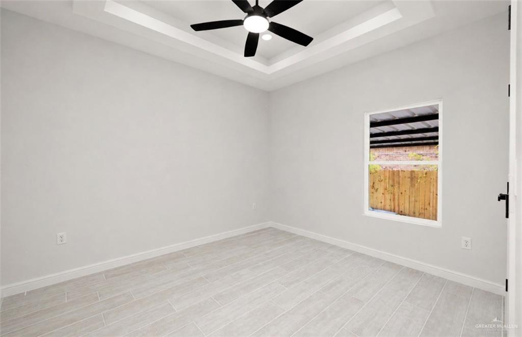 352 Elias Lopez Street Rio Grande City, TX 78582 - Photo 9 of 15 an empty room with a window and a ceiling fan