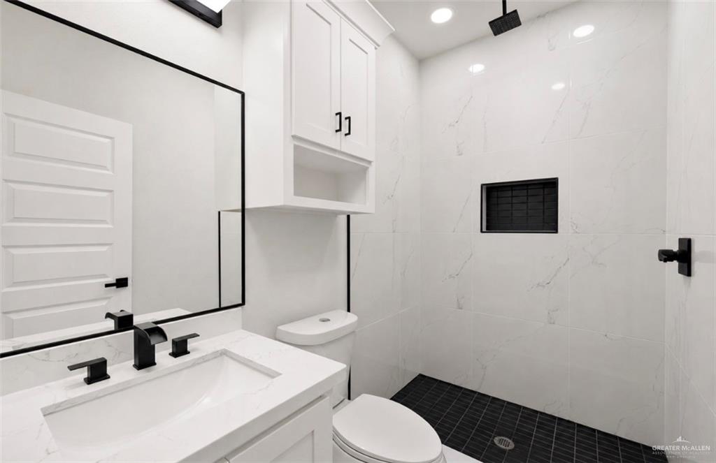 352 Elias Lopez Street Rio Grande City, TX 78582 - Photo 10 of 15 a bathroom with a sink a toilet and shower