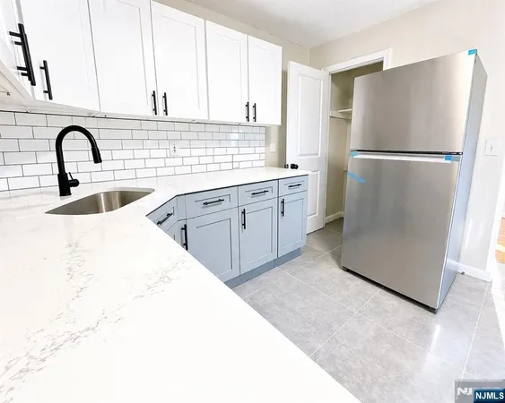 a kitchen with a refrigerator and a sink