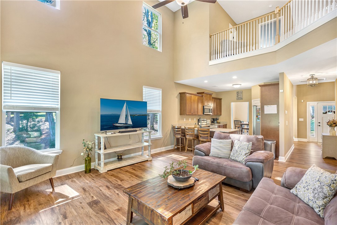 3004 Cobbs Way Anderson, SC 29621 - Photo 12 of 46 Towering ceilings and rich wood floors anchor this grand, open-concept living space.