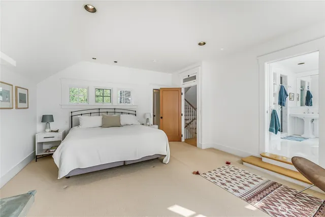 a bedroom with a bed lamp and a dresser