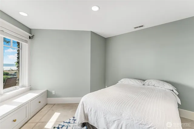 a bedroom with a large bed and a tv