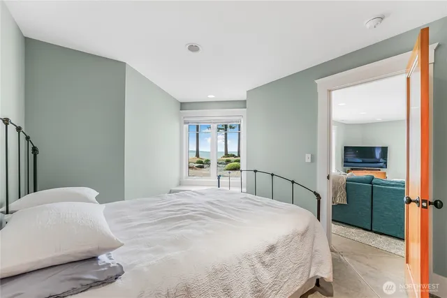 a bed sitting in a bedroom next to a window