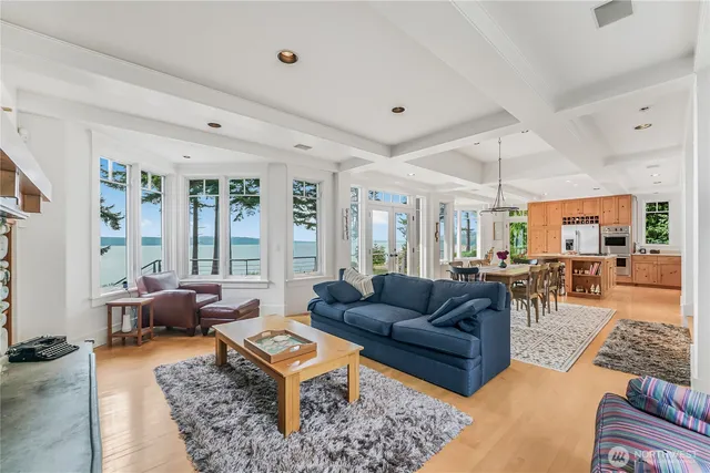 a living room with furniture a large window and a rug