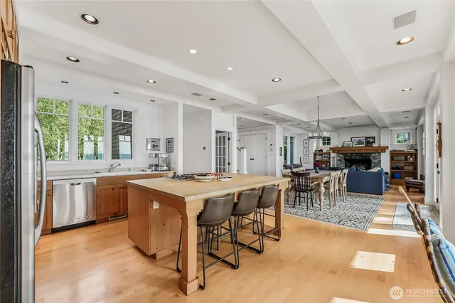 a open kitchen with stainless steel appliances granite countertop a stove and a refrigerator