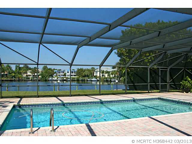 884 Northwest Spruce Ridge Drive Stuart, FL 34994 - Photo 6 of 25 Swimming Pool/Hot Tub/Sauna. Water views from the main living areas across the pool and patio.