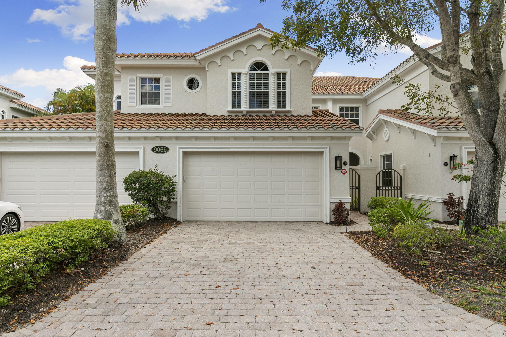 9066 Cascada Way, Unit 101 Naples, FL 34114 - Photo 3 of 51 a front view of a house with a garden