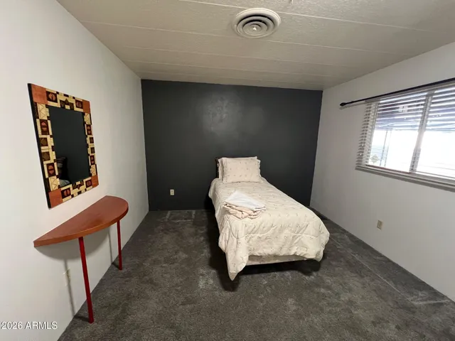 a bedroom with a bed and window