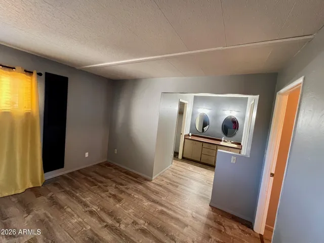 a bedroom with a bed and a mirror