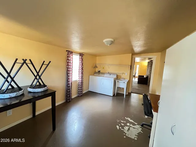 a view of a livingroom with furniture and a window