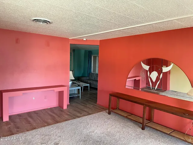 a bedroom with a bed and a dresser next to it