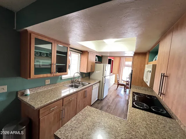 a kitchen with granite countertop a stove and a sink