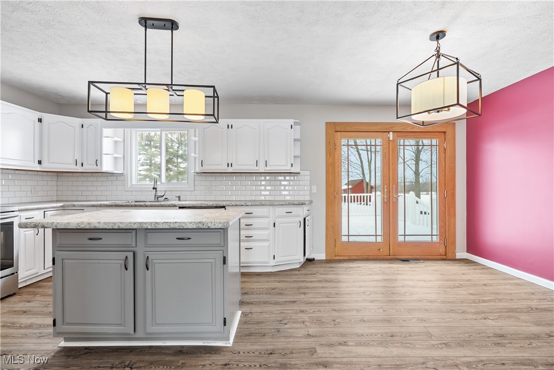 6059 Branch Road Medina, OH 44256 - Photo 7 of 39 Kitchen featuring a center island, white cabinetry, and hanging light fixtures