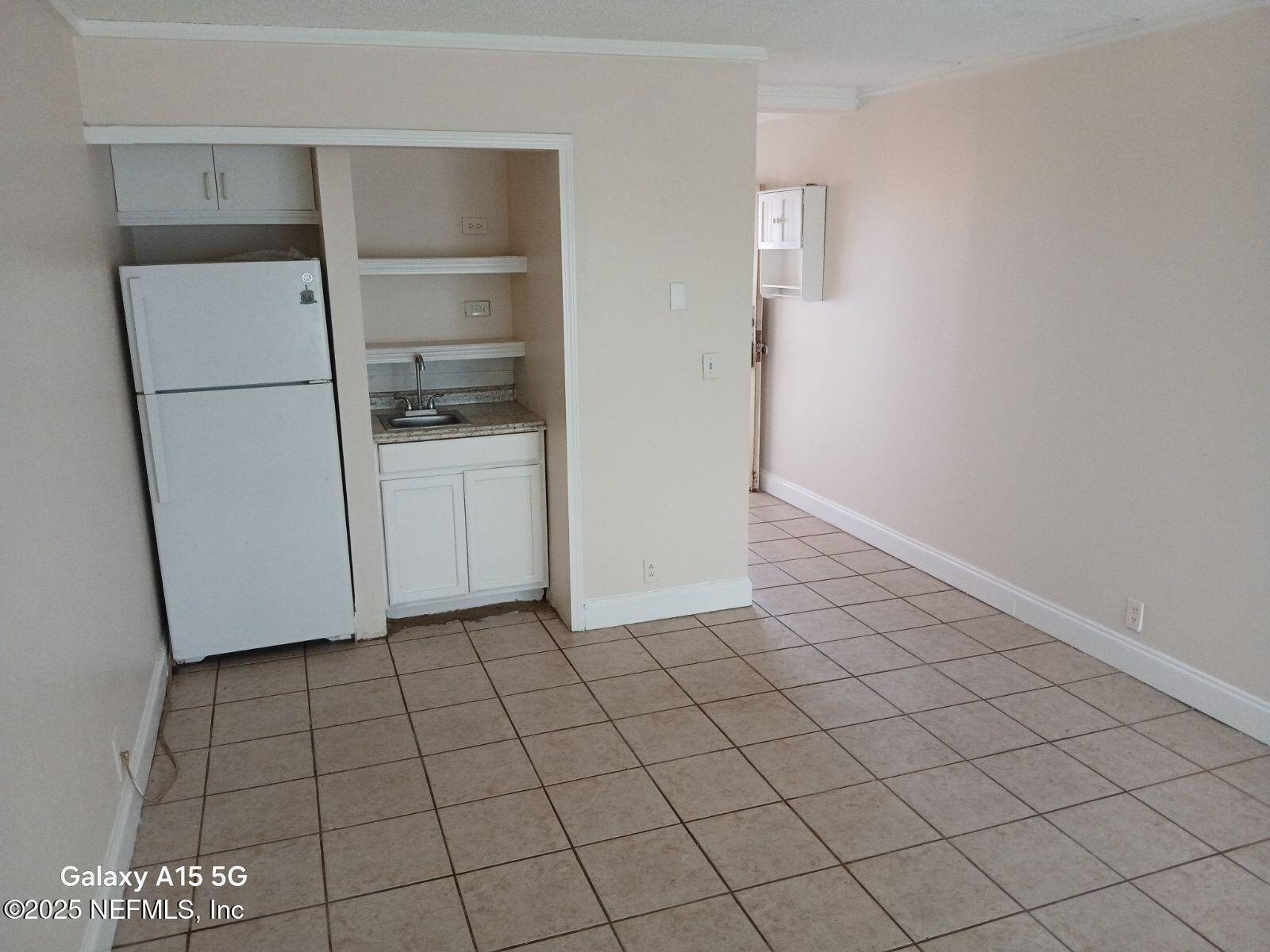 6970 A1A South, Unit 234 St. Augustine, FL 32080 - Photo 5 of 11 a room with a refrigerator and cabinets