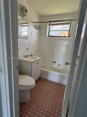 a bathroom with a toilet a sink and a bathtub