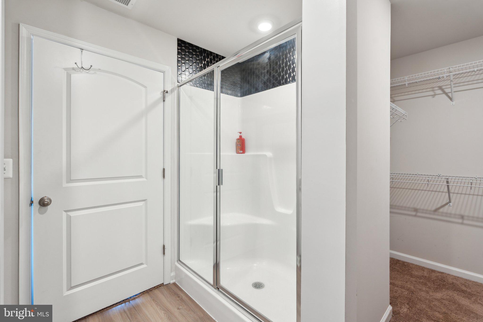 17026 Rollins Road Bowling Green, VA 22427 - Photo 14 of 19 a bathroom with a glass shower door
