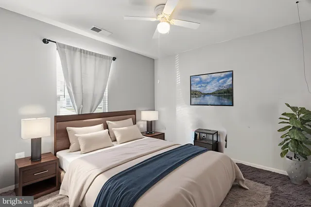 a bedroom with bed and a chandelier