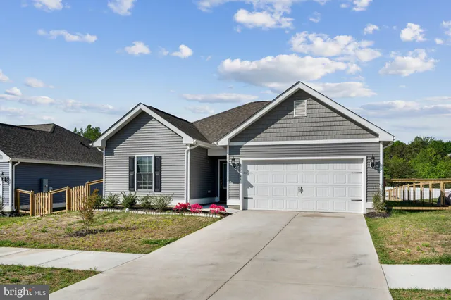 a view of a house with a yard and fence