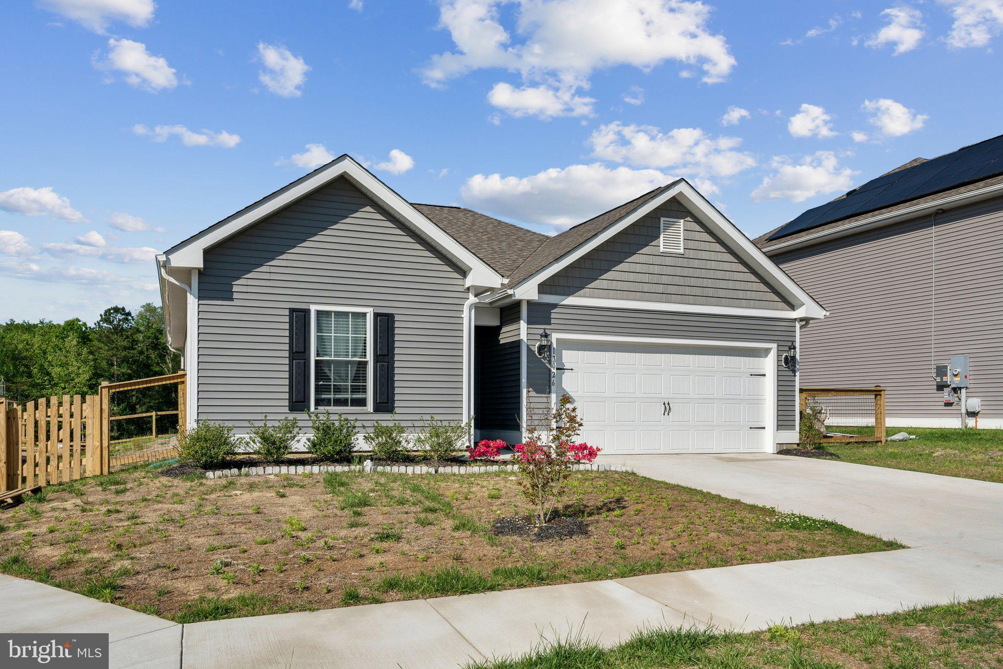 17026 Rollins Road Bowling Green, VA 22427 - Photo 3 of 19 a front view of a house with garden