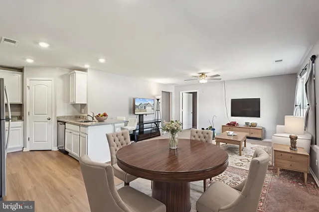 a large kitchen with a table and chairs