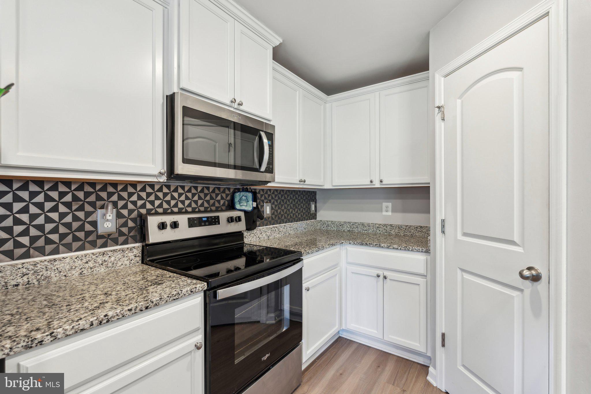 17026 Rollins Road Bowling Green, VA 22427 - Photo 9 of 19 a kitchen with granite countertop cabinets and steel stainless steel appliances