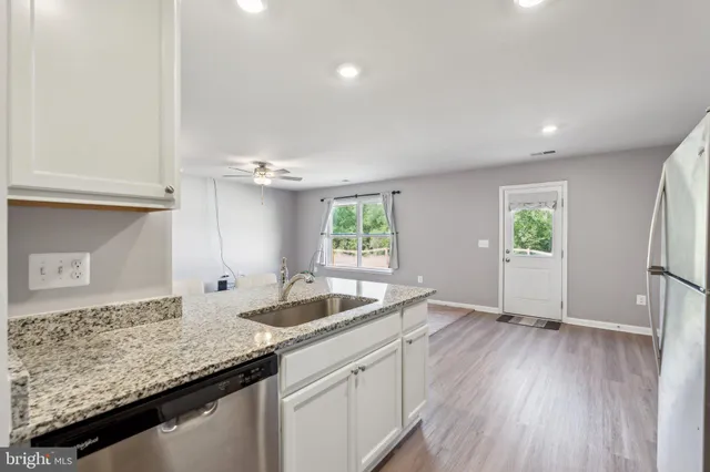 a kitchen with granite countertop a sink and a window