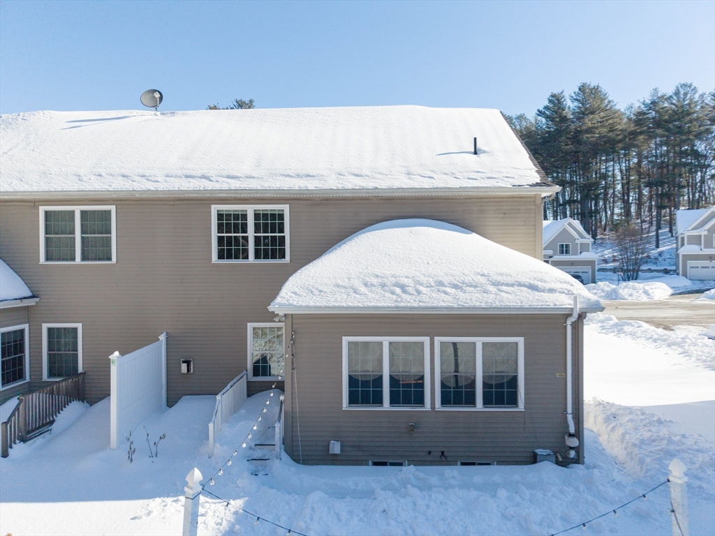 4 Cyrus Way, Unit 4 Northborough, MA 01532 - Photo 16 of 17 a view of a house with a wooden floor and a yard