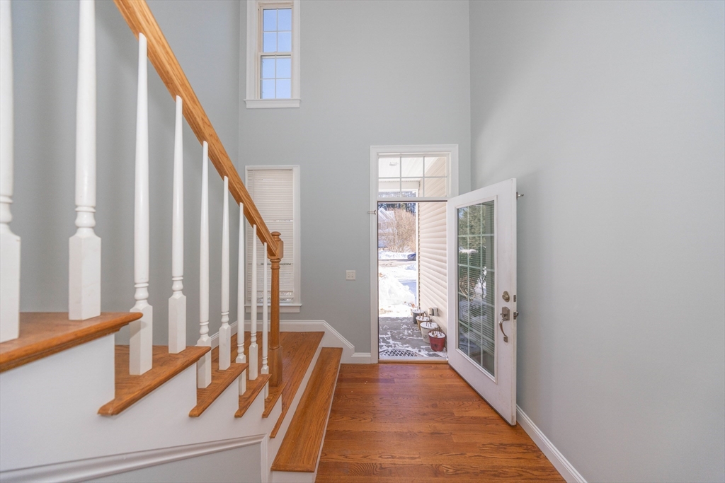 4 Cyrus Way, Unit 4 Northborough, MA 01532 - Photo 3 of 17 a view of a hallway with wooden floor and staircase