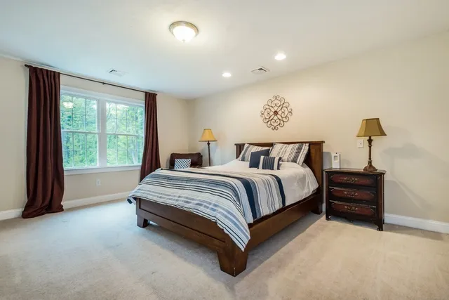 a spacious bedroom with a bed and a table